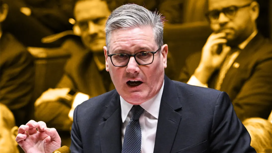 British Prime Minister Sir Keir Starmer speaking during a parliamentary session, with other politicians seated behind him.
