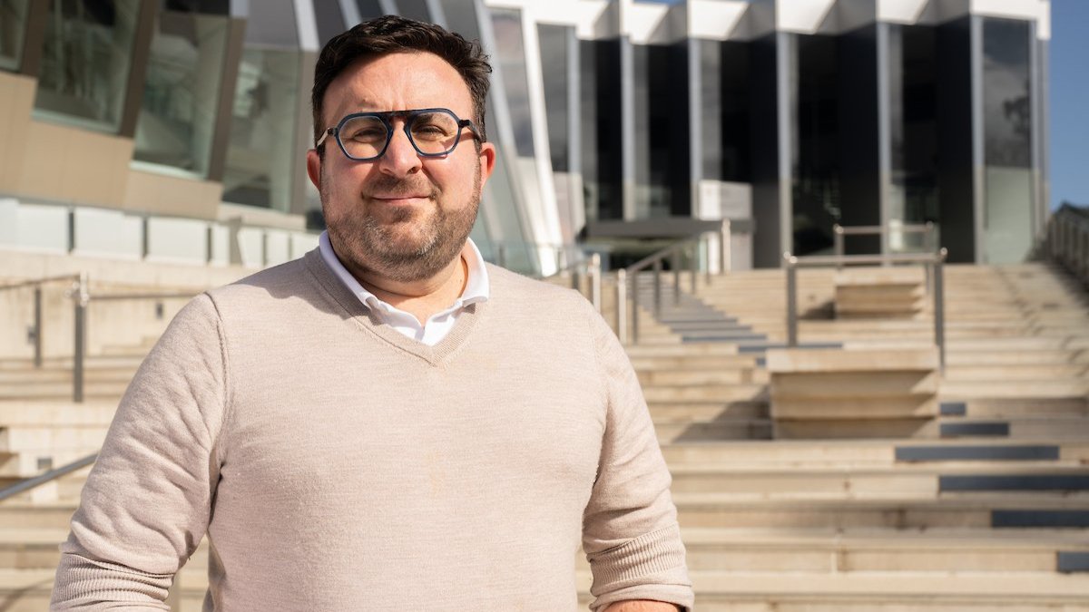 Professor Mark Polizzotto standing in front of the John Curtin School of Medical Research.