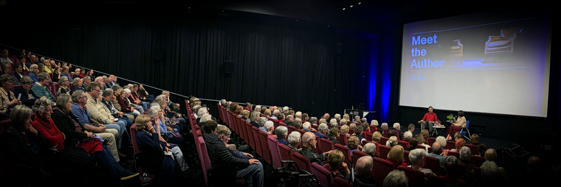 Banner image showcasing the latest Meet the Author event with a fully seated venue.
