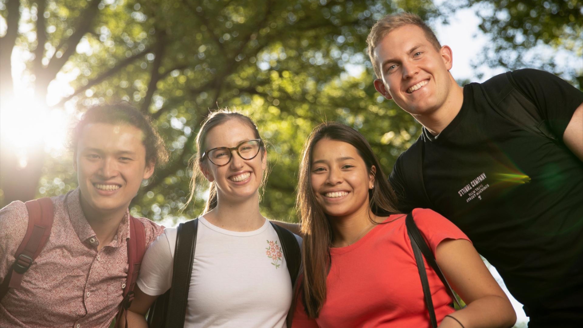 Portrait of 4 students standing on University Avenue