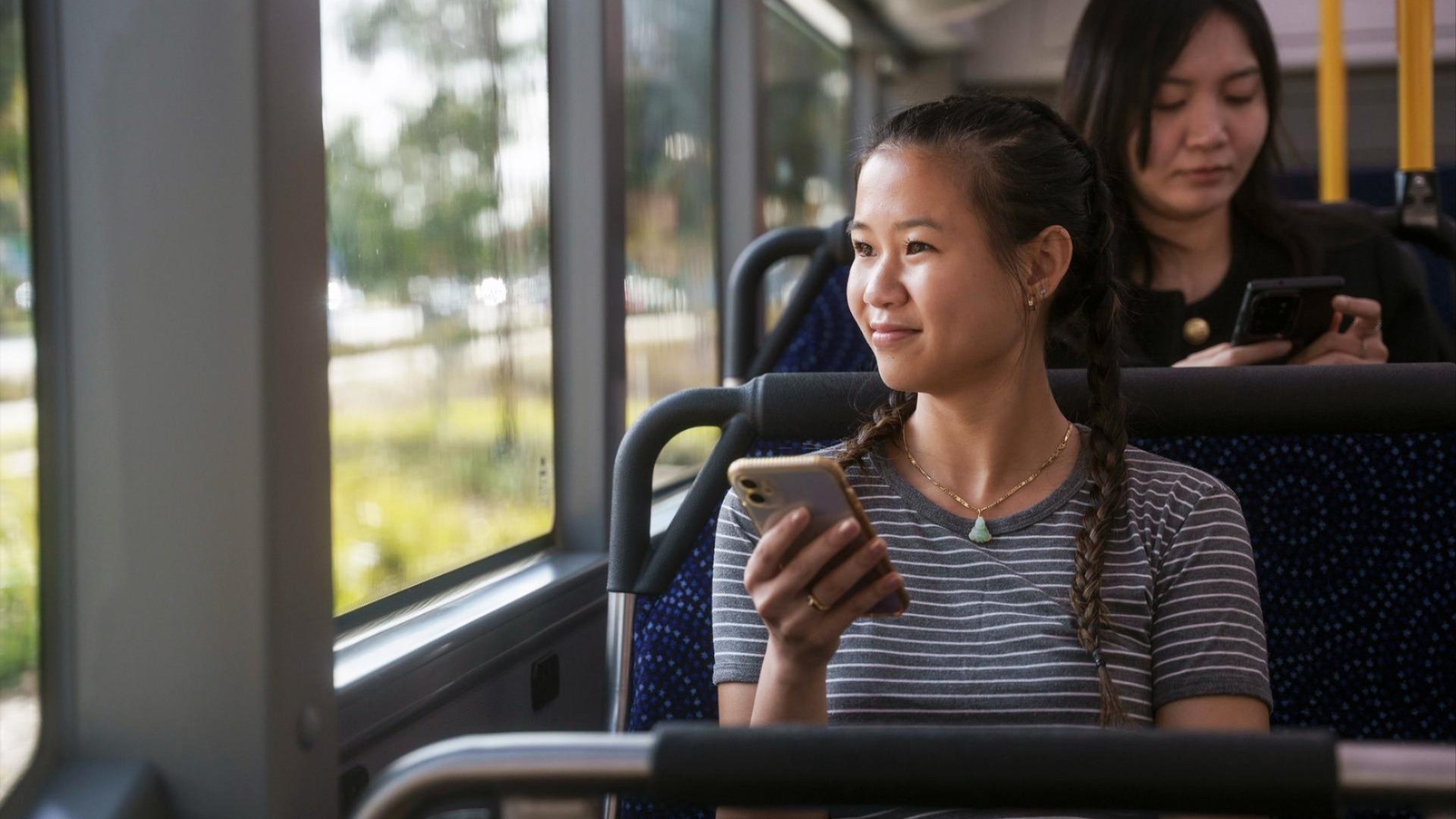 Image of woman seated on a bus