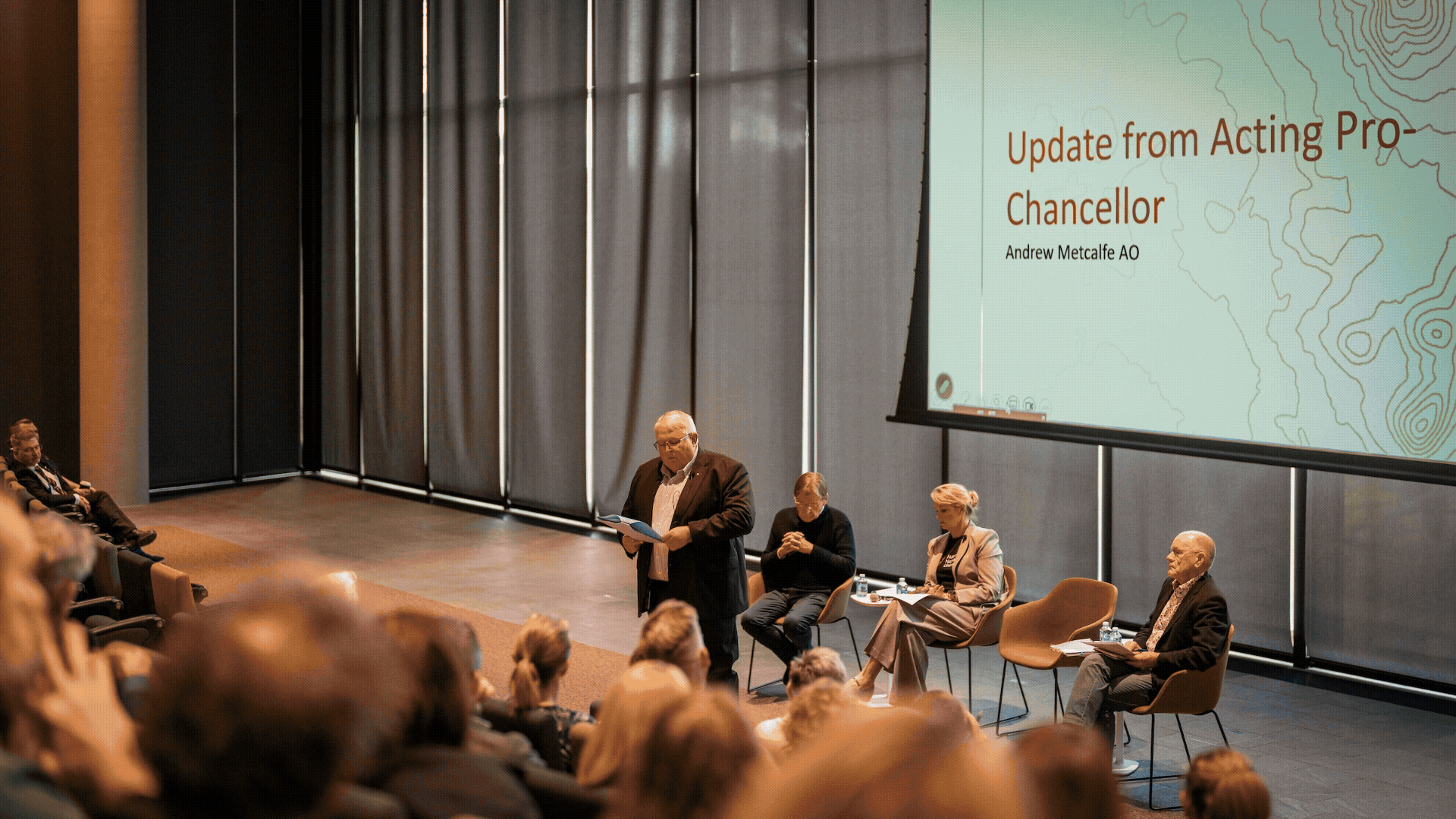 Carousel of images from the ��������Community Meeting on 12 May 2026, showing University leaders speaking with staff in a lecture theatre, including Interim Vice-Chancellor Professor Rebekah Brown, Peter Coaldrake AO, Andrew Metcalfe AO FIPAA and facilitator Professor Peter Kanowski.