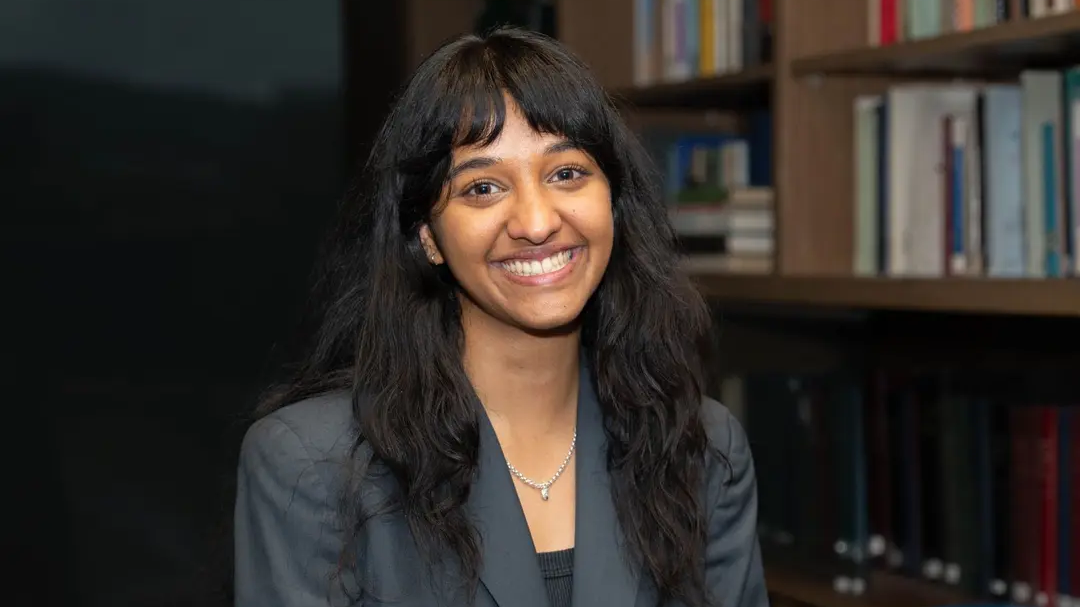 Portrait of Sonali Varma in a grey blazer in a library 