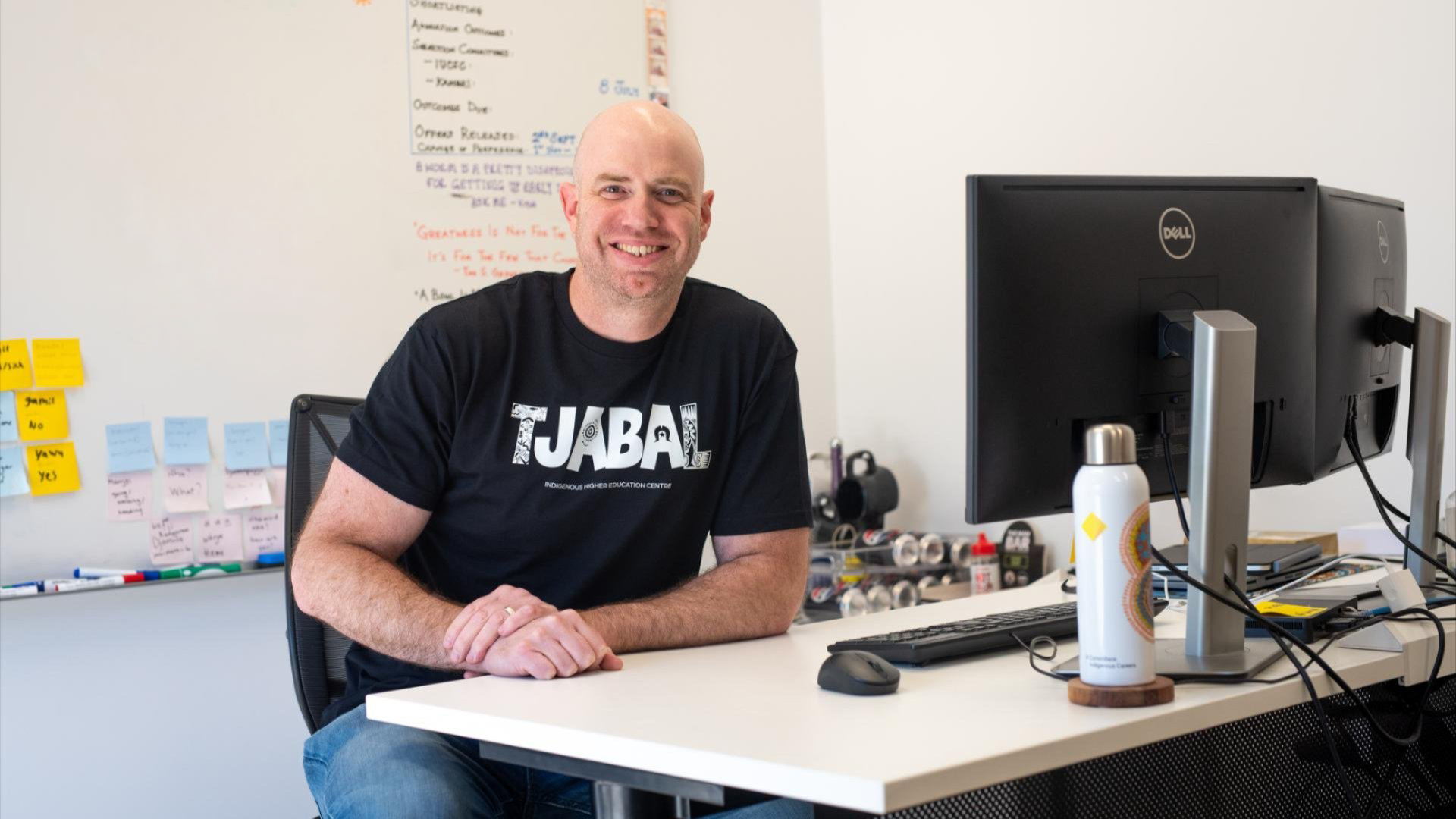 Andrew Coulter sitting at a desk in an office at the Tjabal Indigenous Higher Education Centre.