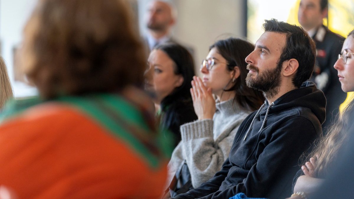 Audience members seated and listening attentively during a presentation.