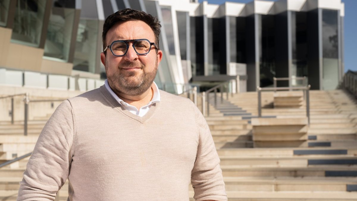 Professor Mark Polizzotto standing in front of the John Curtin School of Medical Research.