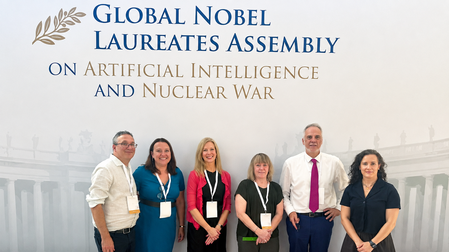 Professor Toni Erskine with five fellow participants at the Global Nobel Laureates Assembly on Artificial Intelligence and Nuclear War.