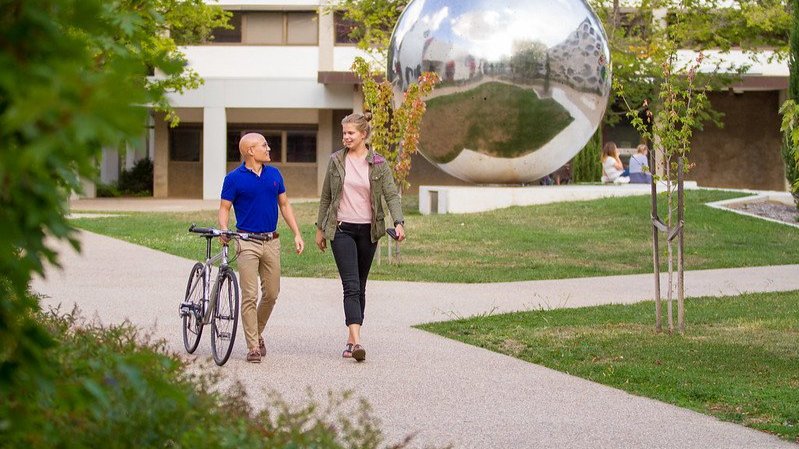 Two adults walking on ANU Campus