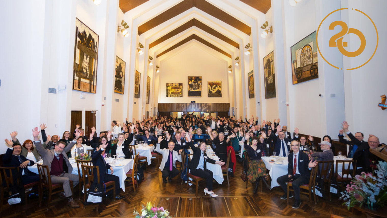 Crawford School community members wave towards the camera during the School&rsquo;s 20th anniversary dinner in the Great Hall at University House