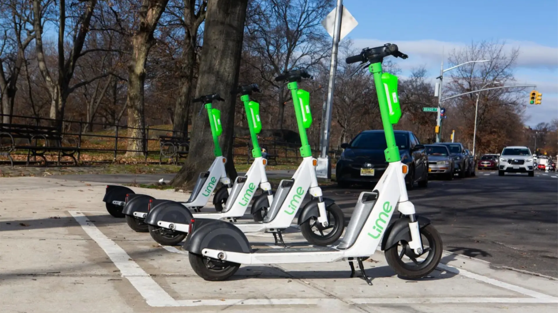 4 Lime e-scooters parked appropriately in a defined spot. 