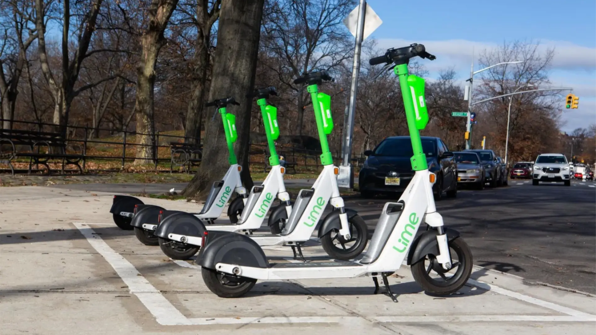 4 Lime e-scooters parked appropriately in a defined parking spot. 